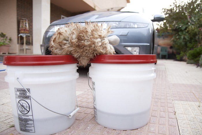 Guante de lana de cordero y dos cubos, imprescindibles si quieres lavar bien a mano tu coche