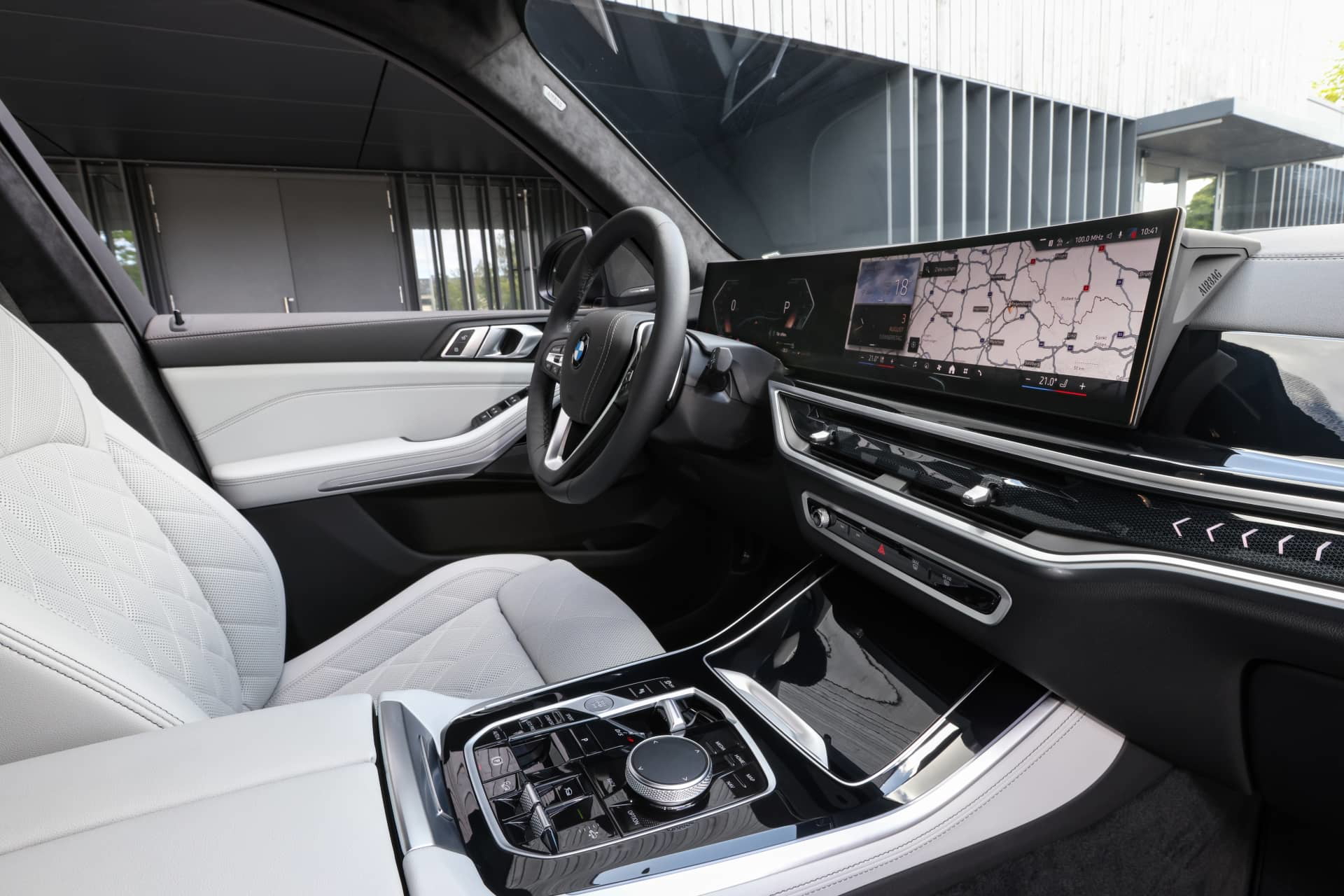 Vista lateral de la cabina del BMW X5 resaltando su lujoso acabado y tecnología.