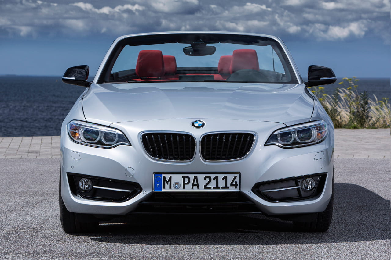 Vista frontal BMW Serie 2 Cabrio con capota plegada y acabados cromados.
