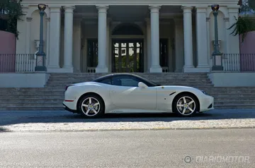 Vista lateral Ferrari California T aparcado frente a edificio clásico