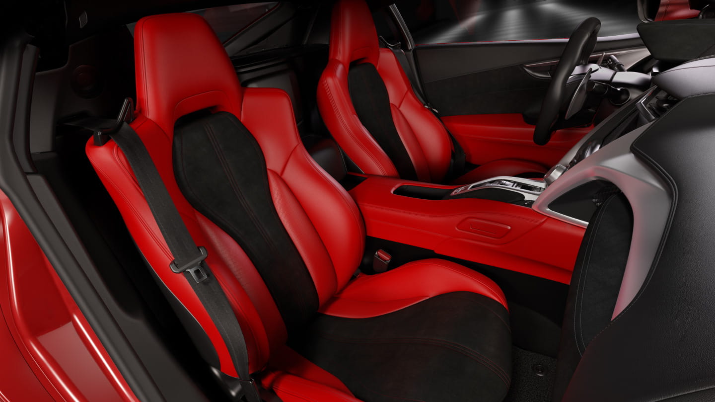 Vista de los asientos deportivos de cuero rojo del Honda NSX, con detalle de costuras.