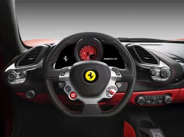 Vista del volante del Ferrari 488 con logotipo prominente e instrumentación.