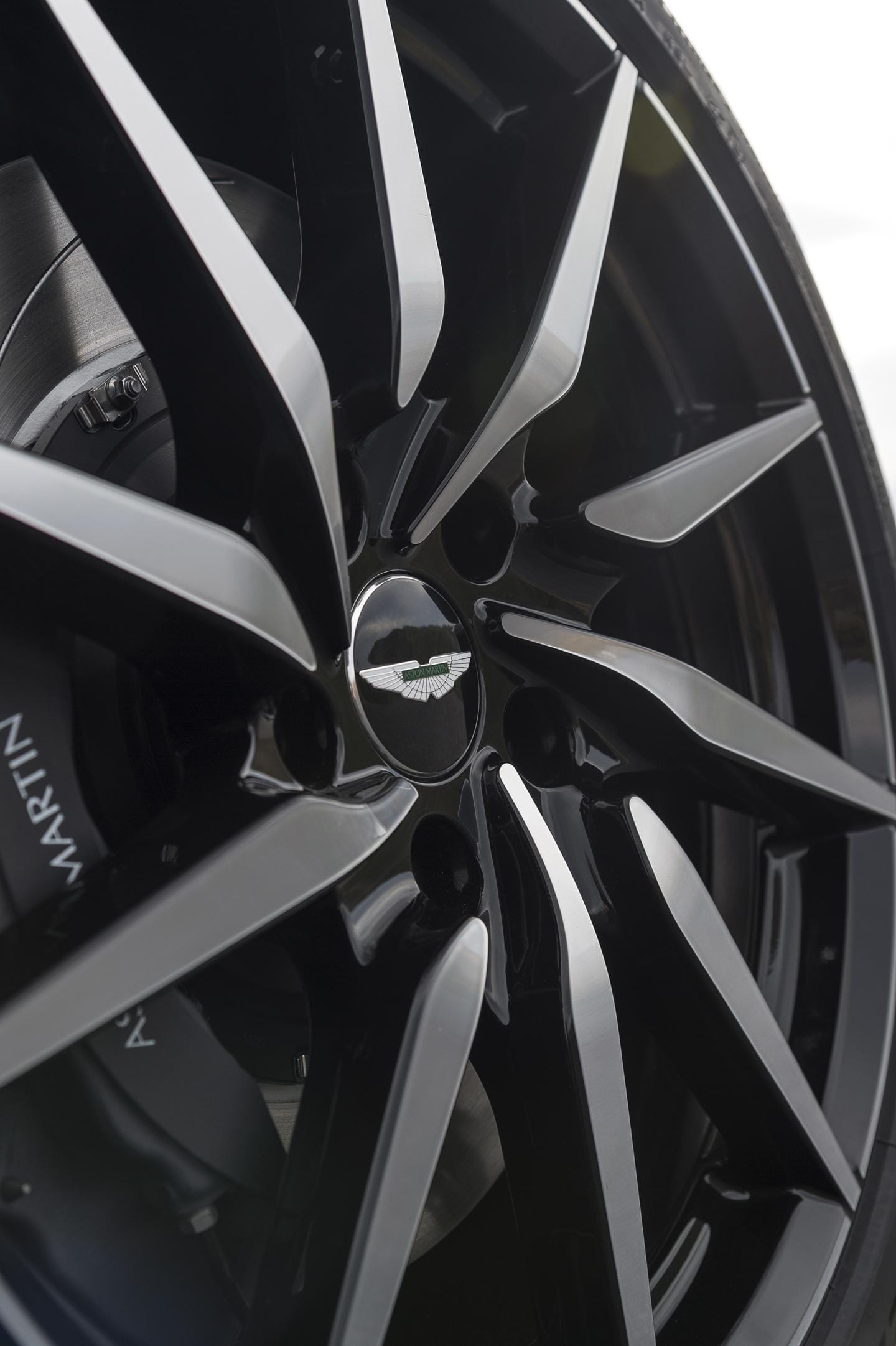 Primer plano de un rin del Aston Martin DB11, mostrando la marca y diseño.