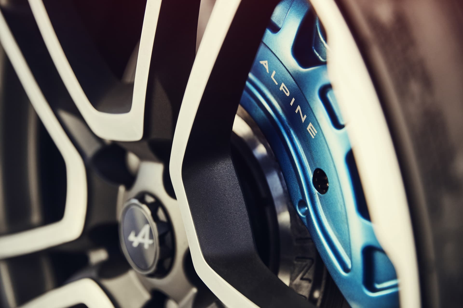 Vista cercana de los frenos de disco del Alpine A110 con pinzas en azul.