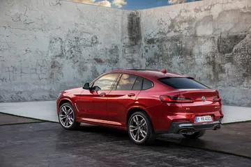 Vista en ángulo de la parte trasera y lateral del BMW X4, destacando su diseño deportivo.