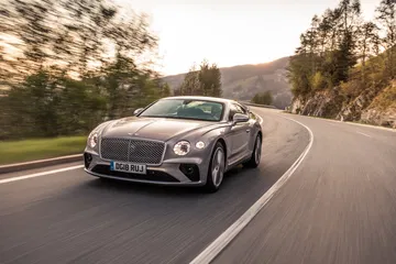 Vista lateral del Bentley Continental GT en un paisaje montañoso. Vista lateral del Bentley Continental GT en un paisaje montañoso.