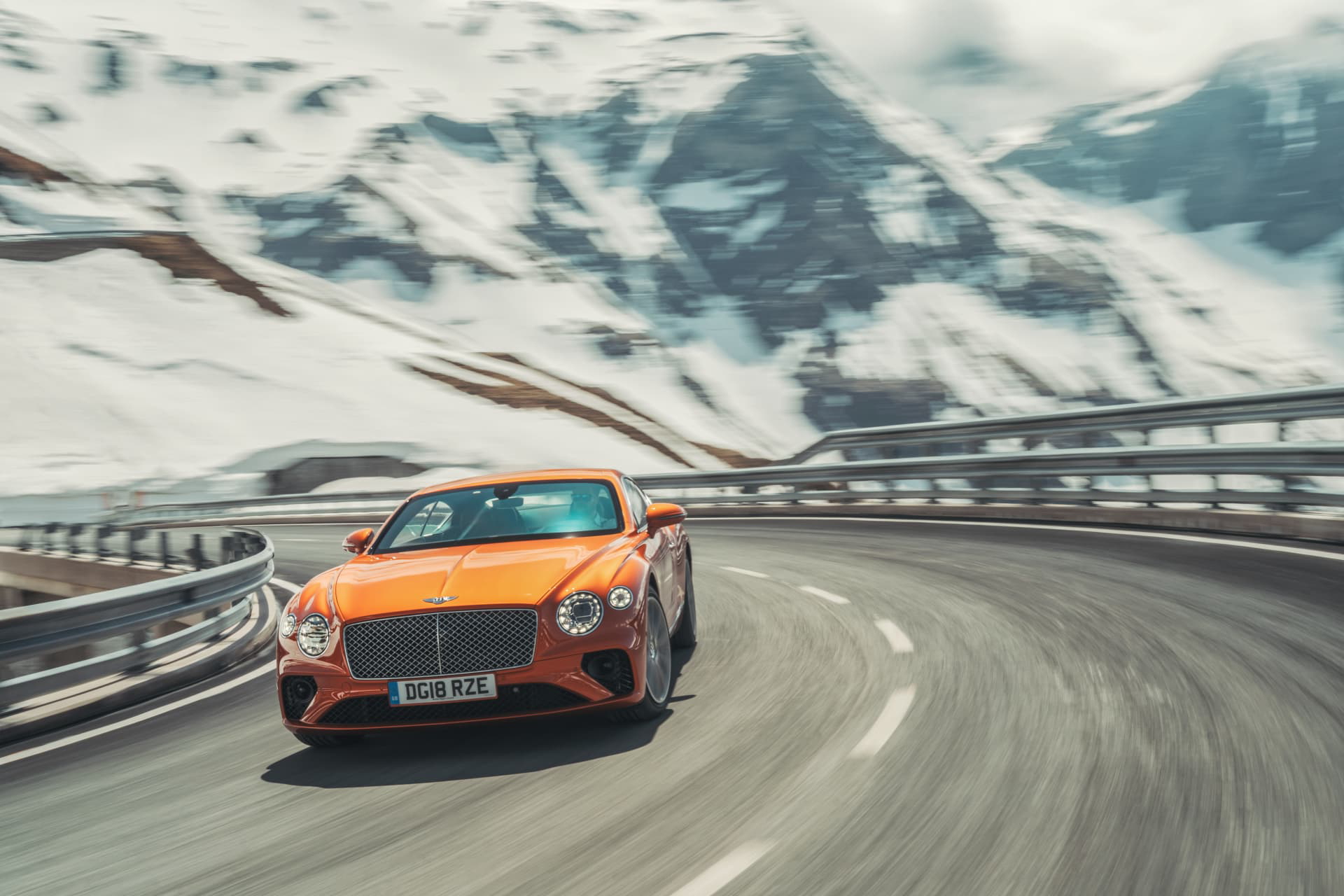 Dinamismo y elegancia en el Bentley Continental GT, capturados en carretera de montaña.