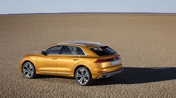 Vista lateral del Audi Q8 que muestra su perfil dinámico y llantas deportivas.