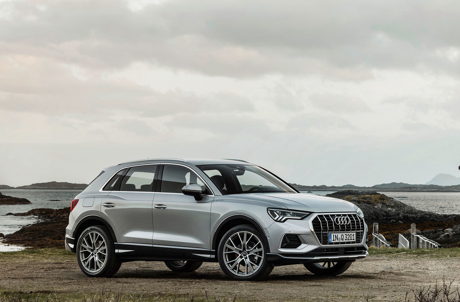 Vista lateral del Audi Q3 en movimiento mostrando el perfil y llantas.