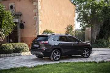 Vista trasera y lateral del Jeep Cherokee, apreciando su diseño robusto.