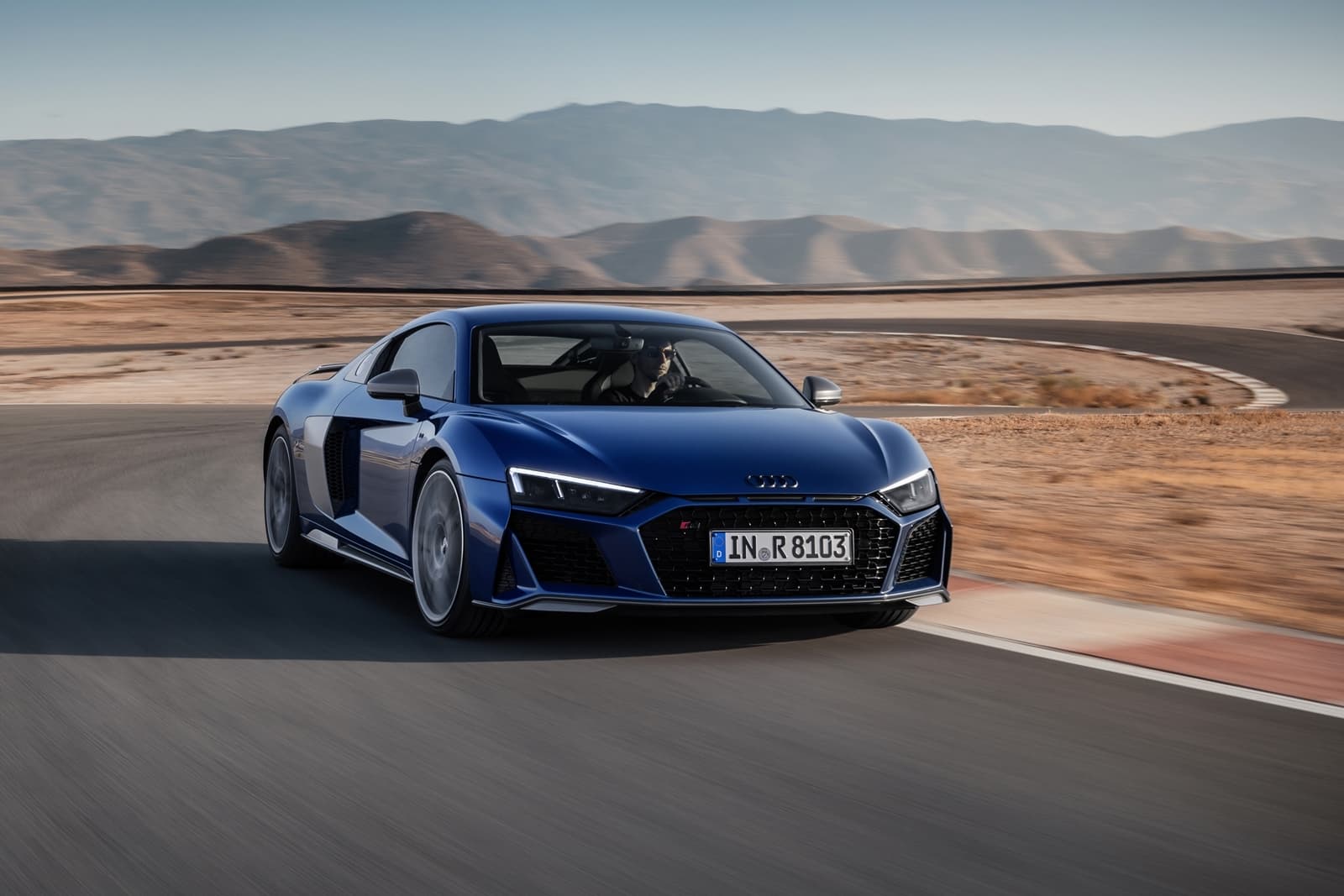 El Audi R8 domina el asfalto con su diseño lateral aerodinámico y líneas agresivas.