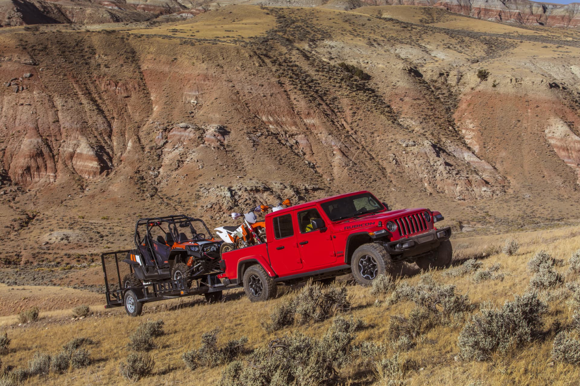 rugged Jeep Gladiator towing in a challenging off-road scenario
