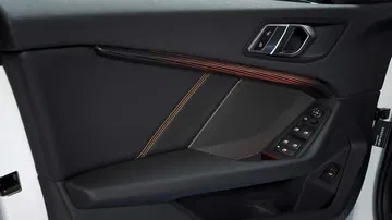 Vista cercana de acabados y controles en la puerta del BMW Serie 1.