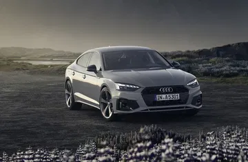Audi A5 2020 con acabado S Line posando en terreno abierto.