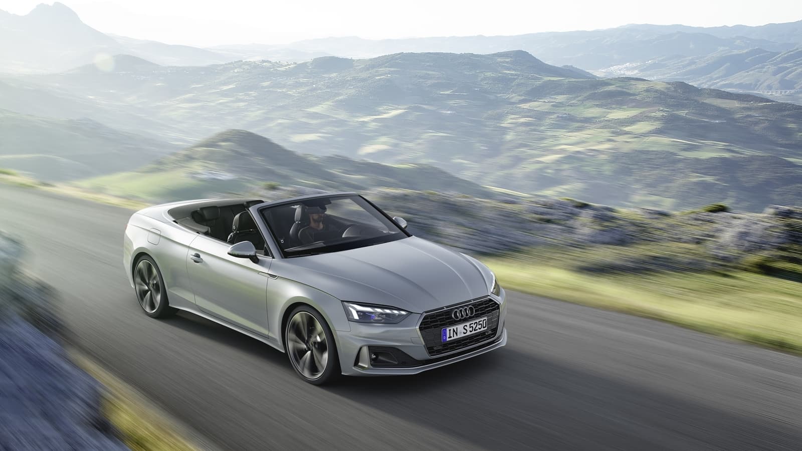 Vista dinámica del Audi A5 Cabriolet recorriendo una carretera de montaña