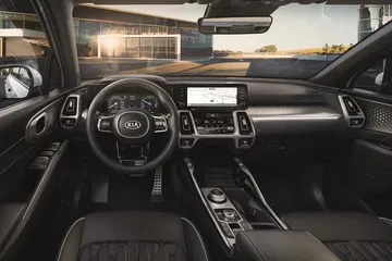 Vista del cockpit con volante multifunción y pantalla táctil integrada.