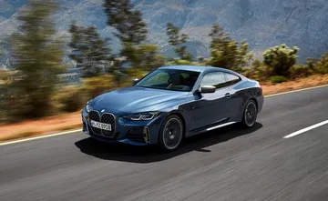 Vista dinámica del BMW Serie 4 en carretera, exhibiendo su perfil.