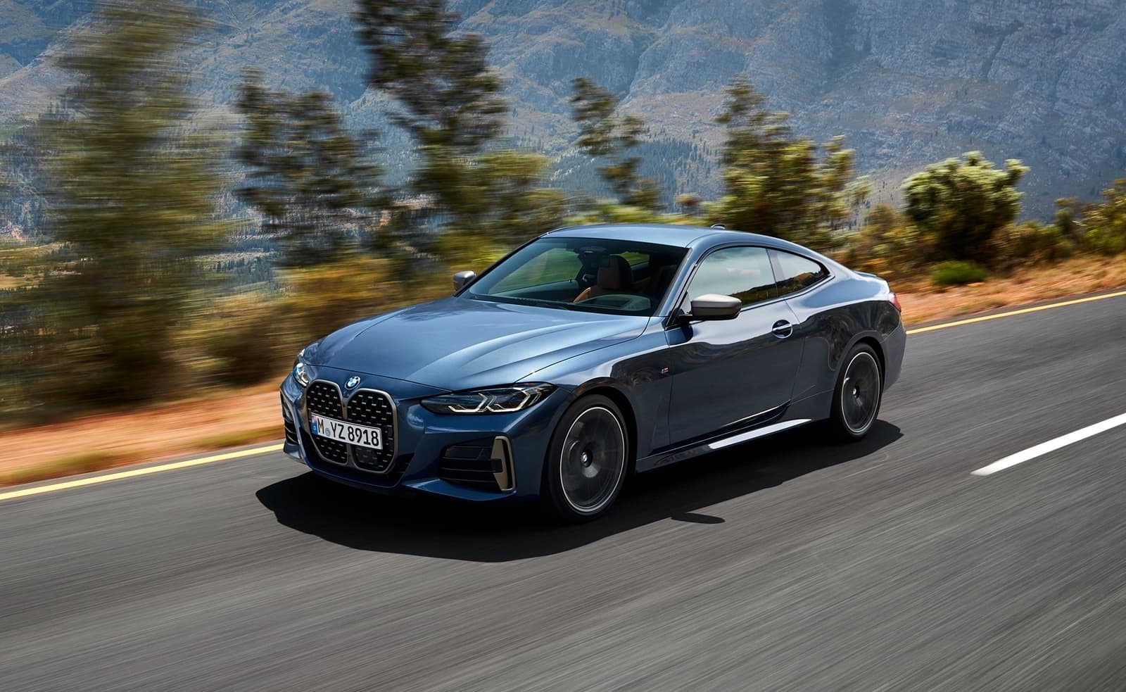 Vista dinámica del BMW Serie 4 en carretera, exhibiendo su perfil.
