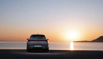 Vista frontal del CUPRA León al amanecer, destacando su diseño agresivo.