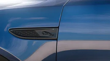 Vista cercana del emblema lateral del Jaguar E-PACE, resaltando su diseño distintivo.