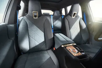 Vista de los asientos traseros de lujo del BMW iX, destacando su confort y diseño moderno.