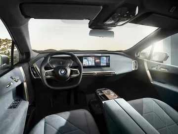 Vista lateral de la cabina del BMW iX destacando su moderno diseño y tecnología.