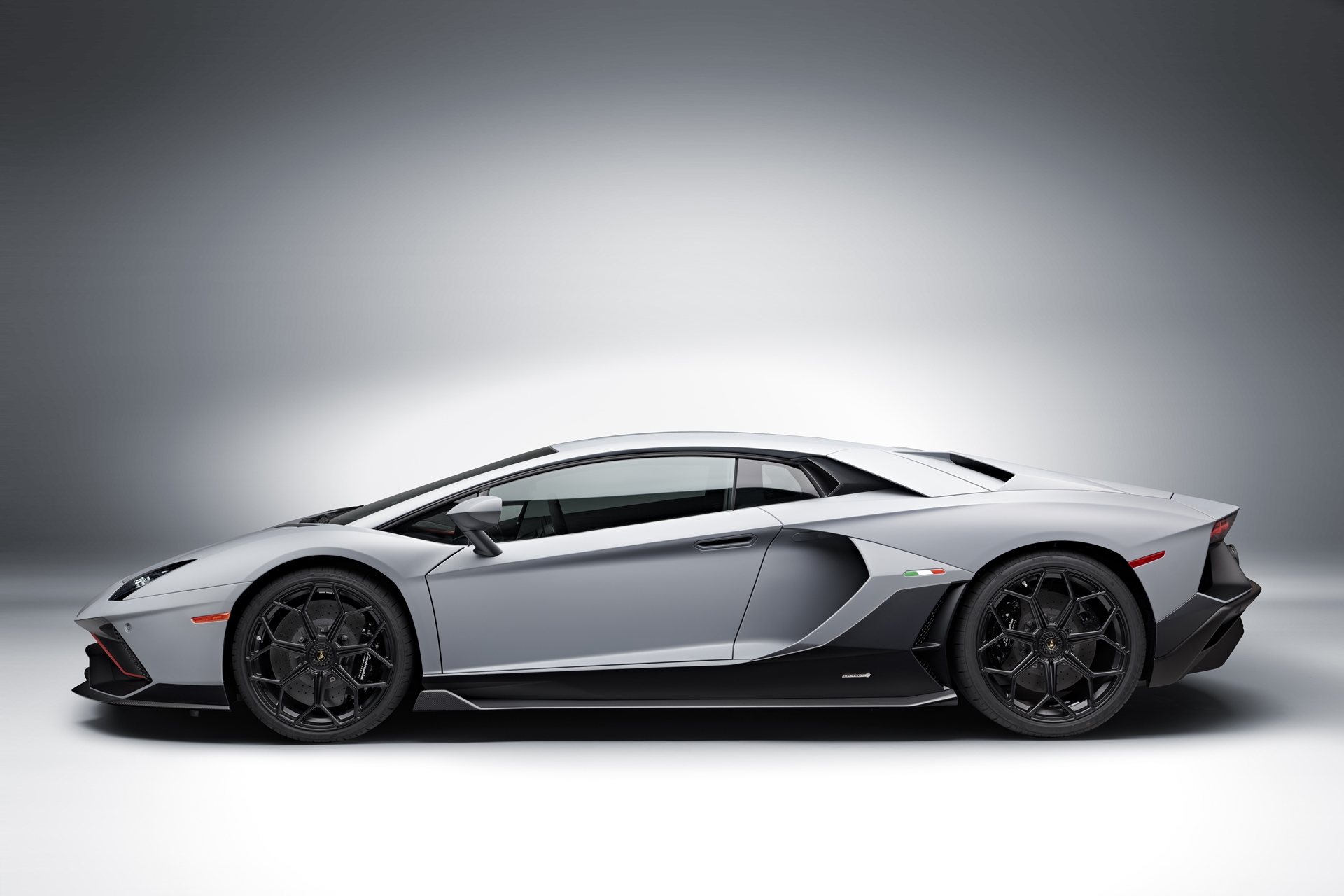Vista dinámica lateral del Lamborghini Aventador que destaca sus líneas agresivas.