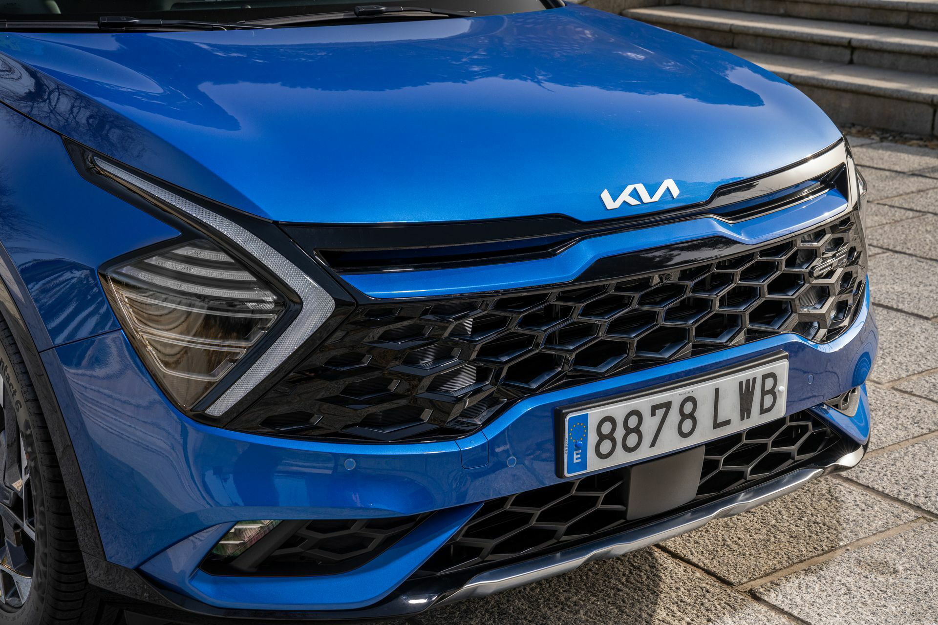 Vista cercana de la parrilla y faros del Kia Sportage, destacando su diseño audaz.
