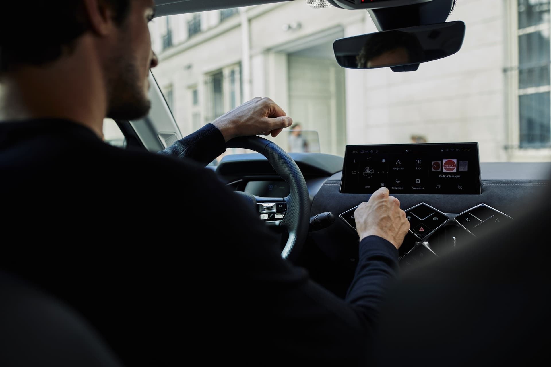Vista de la cabina del DS 3 desde el punto de vista del conductor enfocando el volante y el panel de instrumentos.