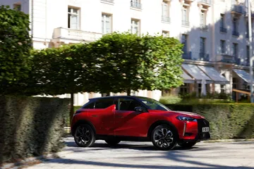 Vista lateral del DS 3 en color rojo destacando su diseño compacto y deportivo.