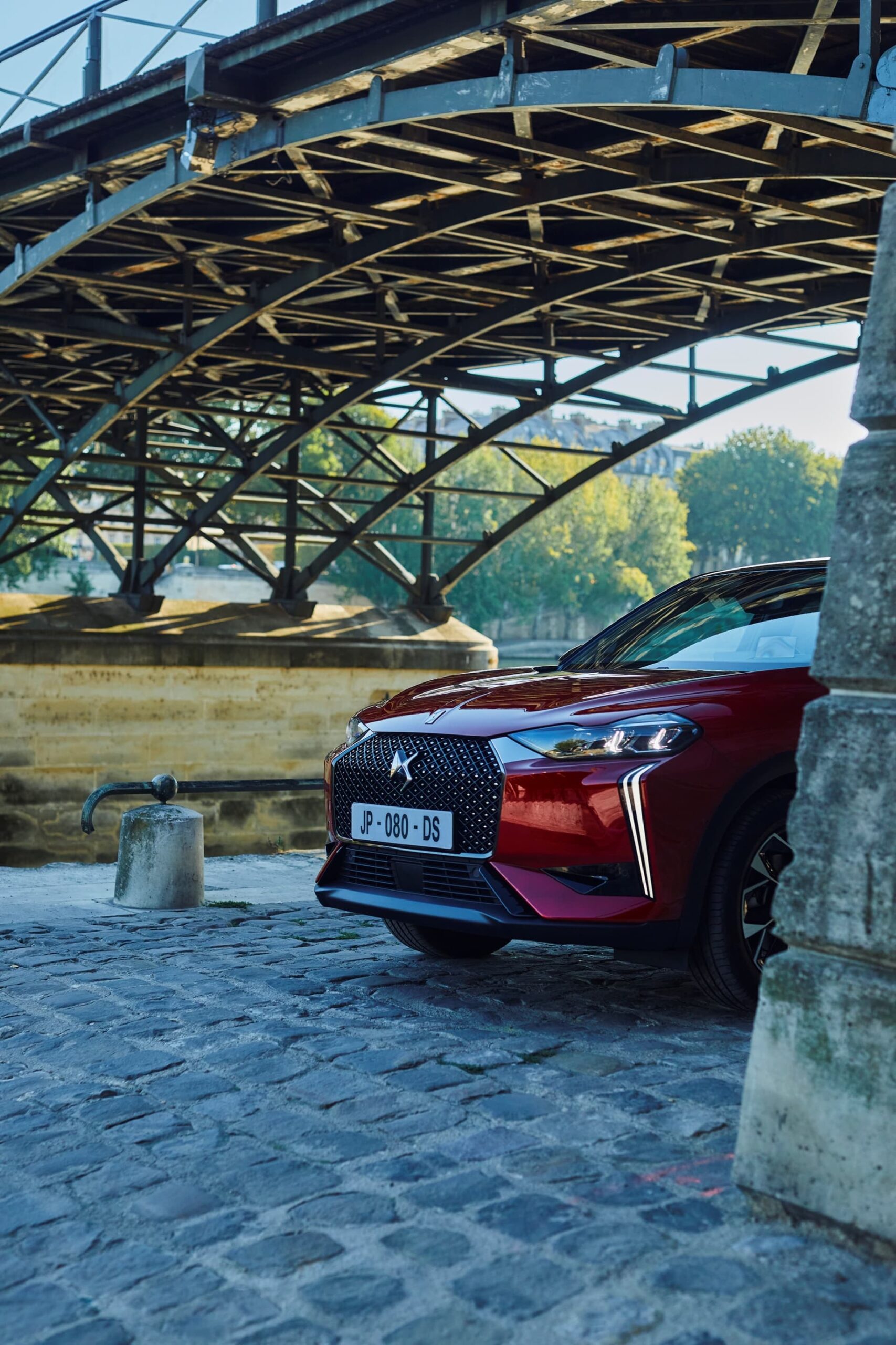 Vanguardista DS 3 estacionado bajo estructura, enfatiza frontal dinámico y techo flotante.