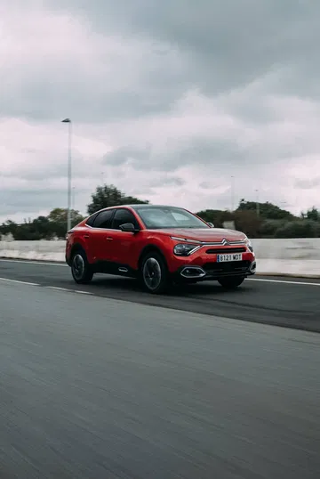 Citroën C4 X en movimiento mostrando su elegante línea lateral.