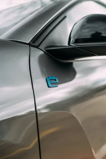 Vista enfocada de la insignia lateral “e” del Citroën C4 X, simbolizando su versión eléctrica.