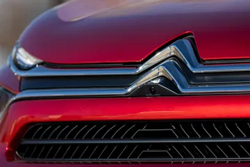 Vista cercana del emblema Citroën en C4 X destacando su diseño icónico