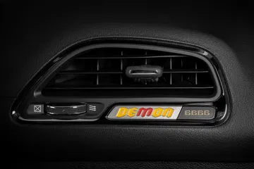 A Yellow And Red Demon Instrument Panel Badge Calls Out The Four
