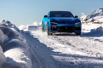 Vista frontal del Ferrari Purosangue desafiando terrenos nevados.