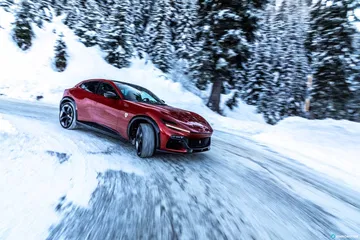Vista dinámica del Ferrari Purosangue rodando sobre nieve.
