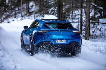 Vista trasera y lateral del Ferrari Purosangue en entorno nevado