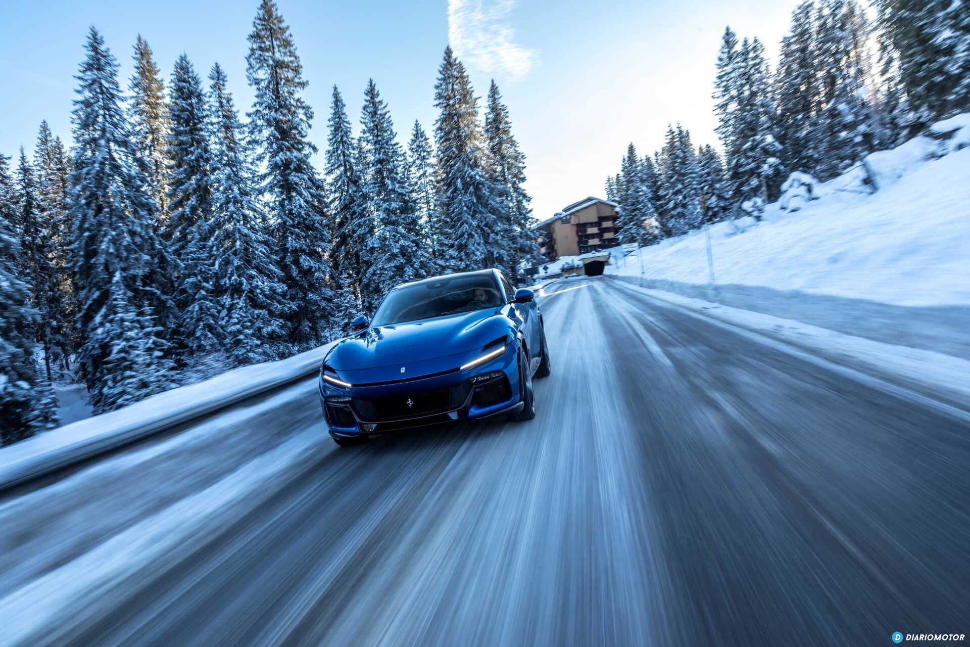 Vista lateral del Ferrari Purosangue deslizándose por una carretera nevada.