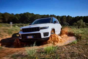 Vista dinámica del Grand Cherokee superando terreno accidentado