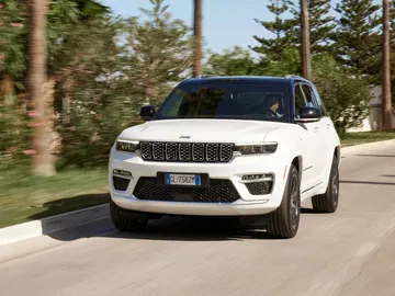 Vista frontal y lateral del Jeep Grand Cherokee en movimiento.