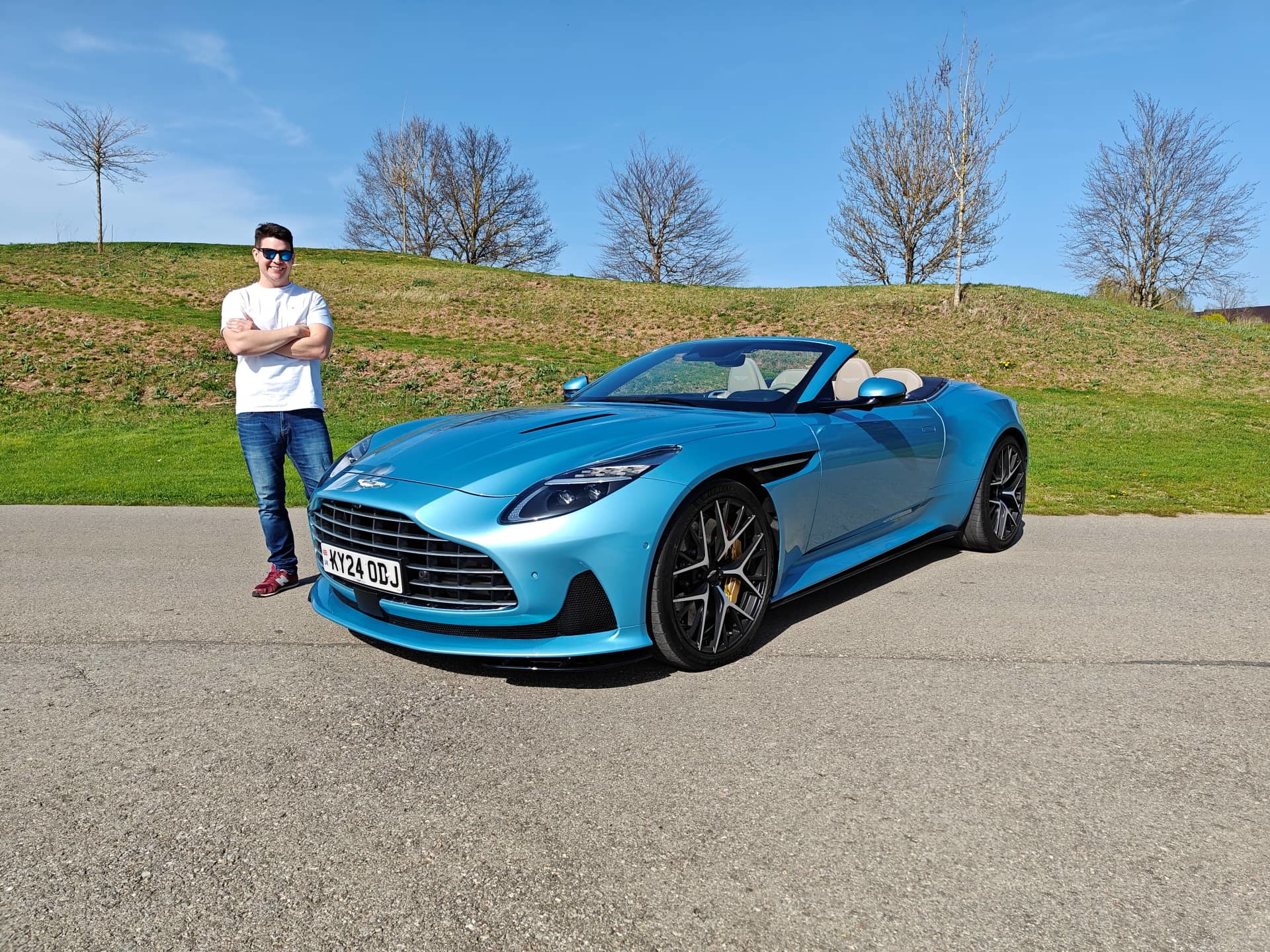 Vista lateral del Aston Martin DB12 Volante, mostrando su diseño elegante y líneas deportivas.