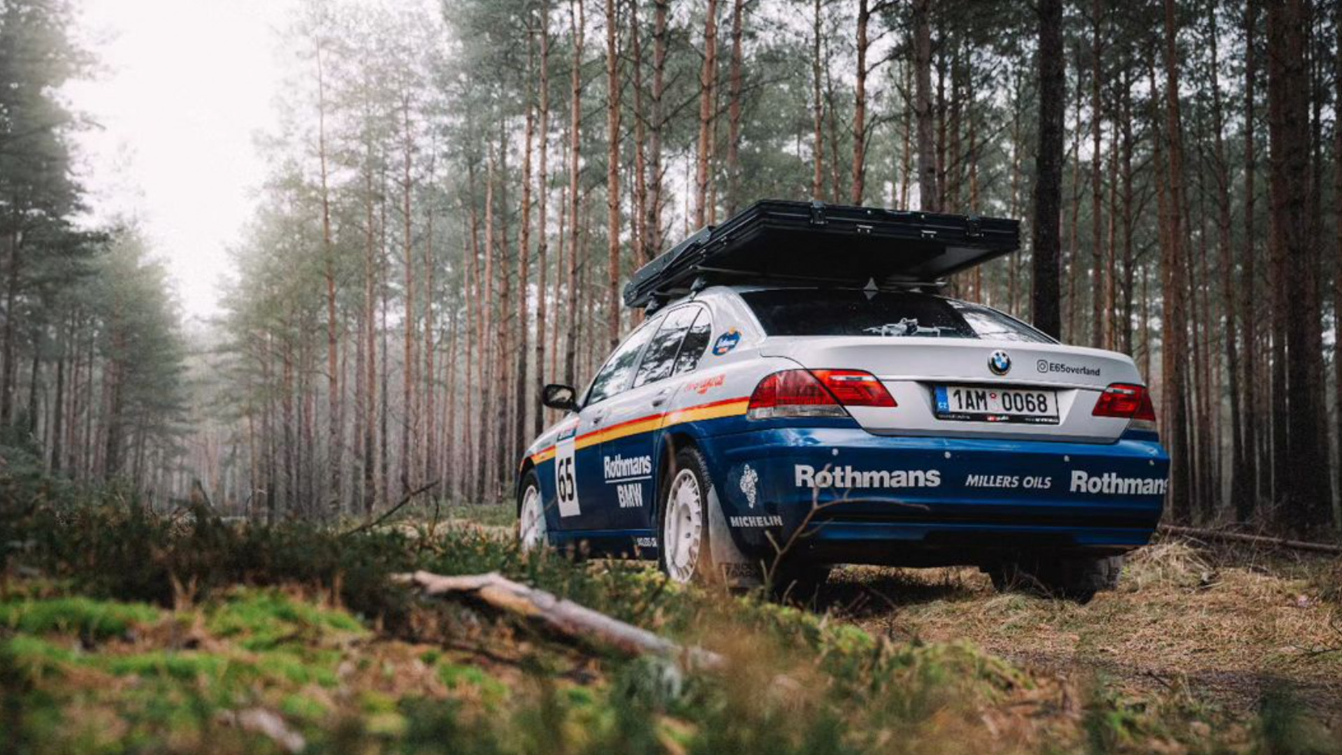 Vista trasera del BMW Serie 7 4x4 preparado para rally en un entorno boscoso