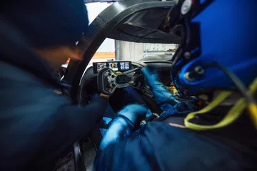 Vista del habitáculo de competición Bugatti, centrada en el volante e instrumentación.