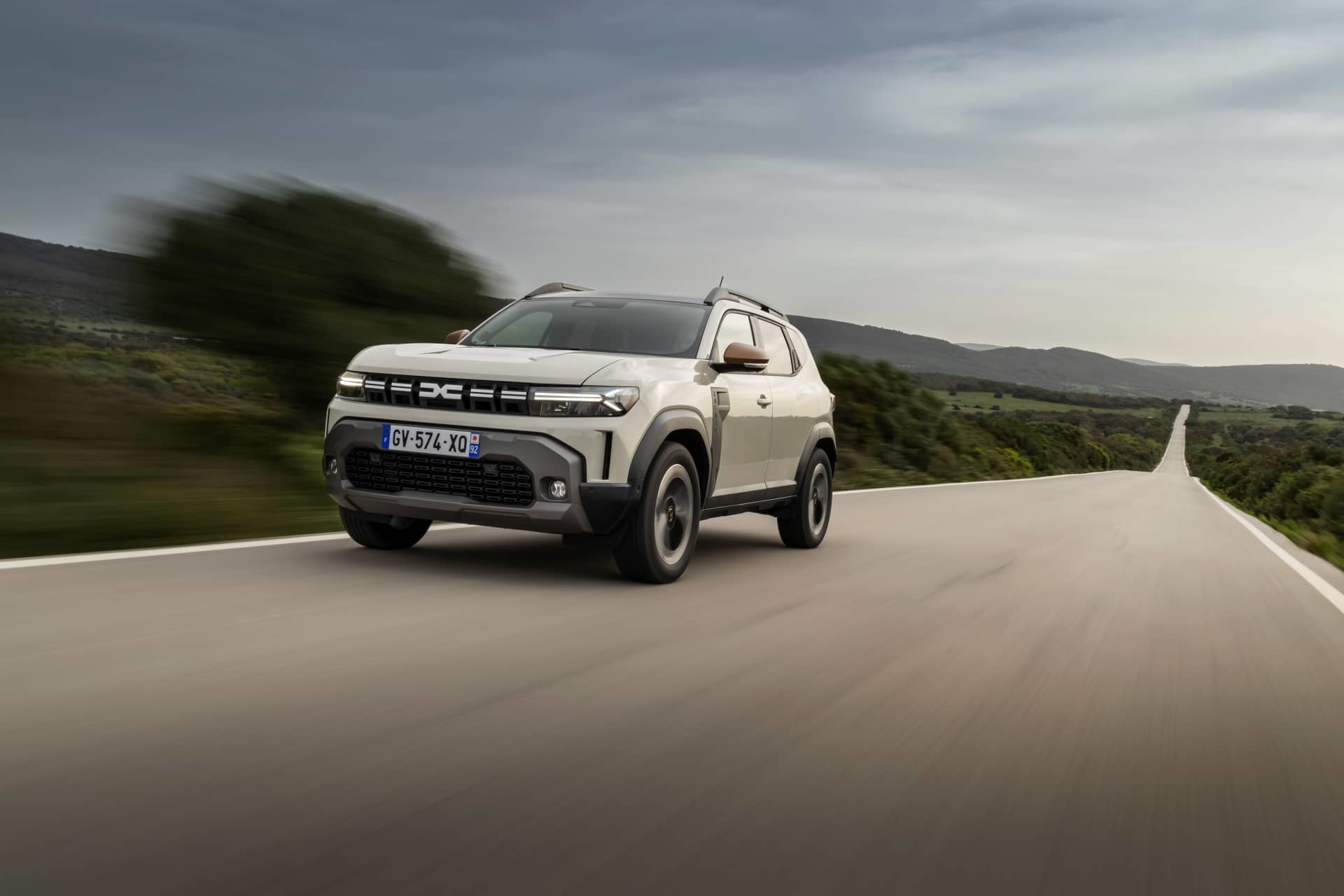 Vista dinámica del Dacia Duster rodando, destacando su diseño frontal y lateral.