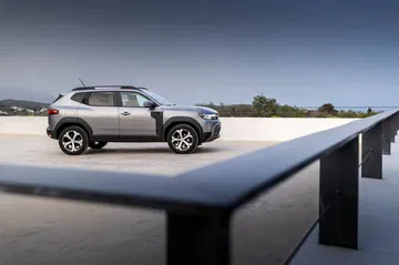 Vista lateral del Dacia Duster destacando su diseño robusto y líneas modernas.