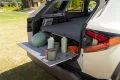 Amplio maletero del Dacia Duster con bandeja y objetos de muestra.
