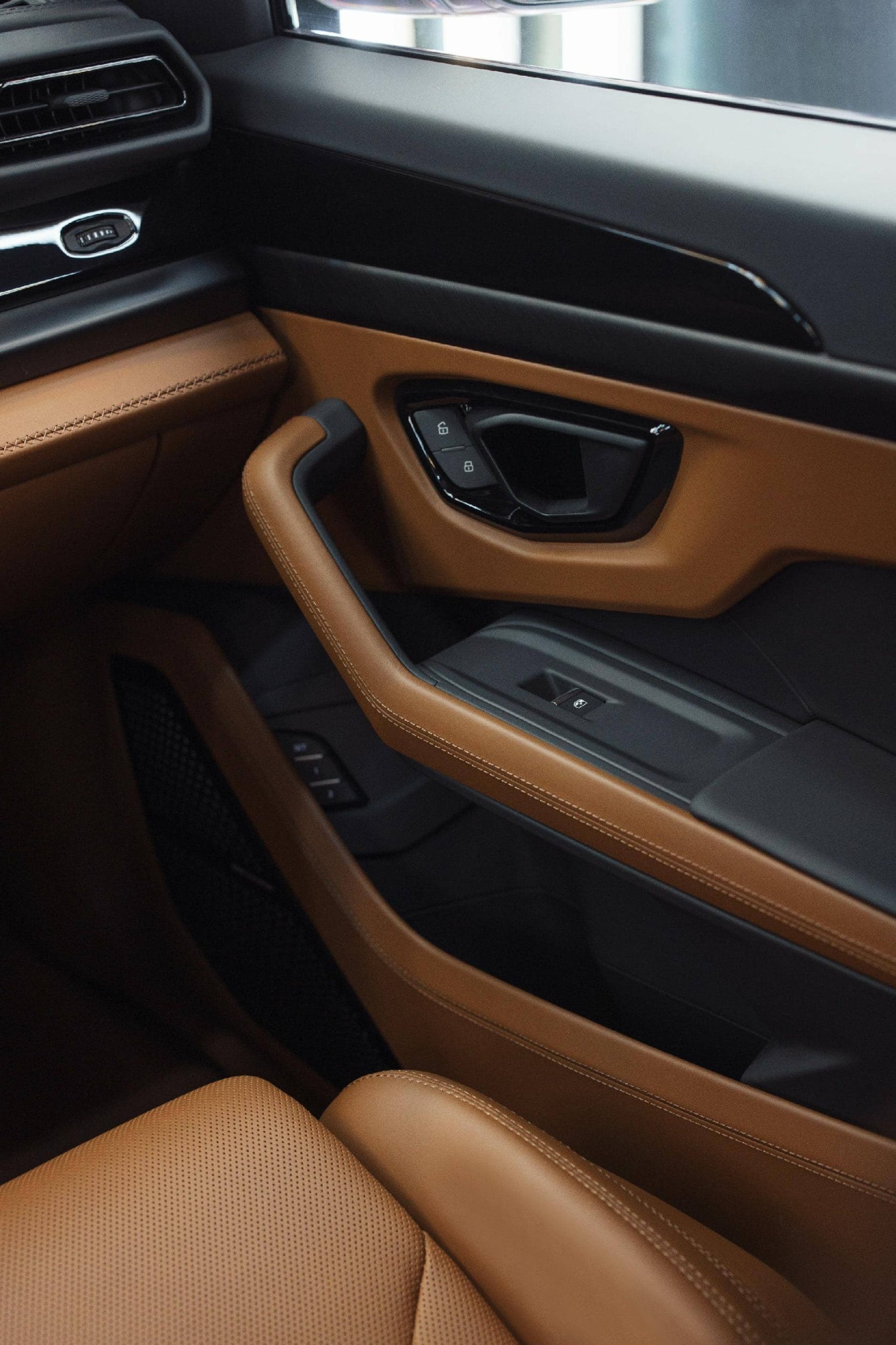 Vista del acabado en cuero de la puerta y zona de asientos del Lamborghini Urus SE 2024.