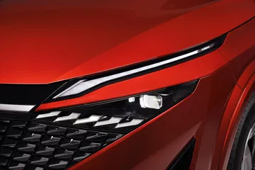 Vista en detalle de la óptica avanzada del Nissan Qashqai 2024 acabado en rojo.