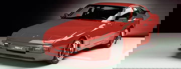Vista lateral y delantera del Porsche 944 en color rojo, clásico de los 80.